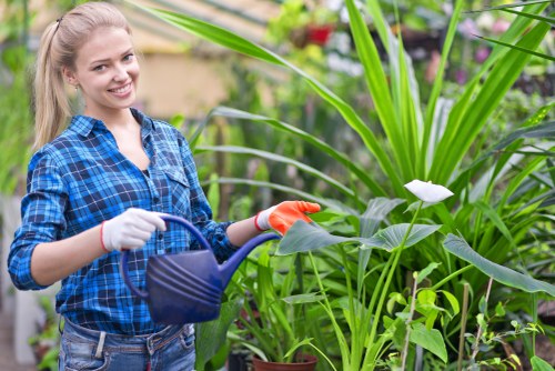 Gardener carrying out safe outdoor work with tools and PPE