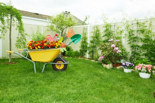 Careful hedge trimming along a Beddington driveway and path