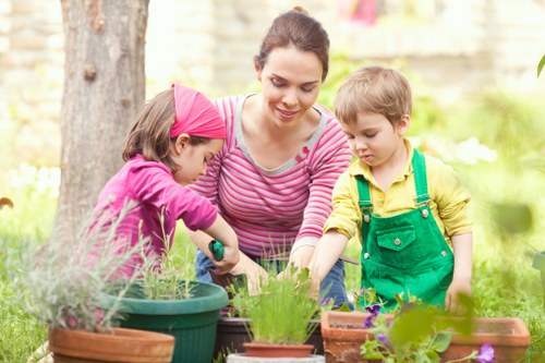 Professional gardeners following safe working procedures